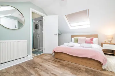 a bedroom with a bed and a mirror at 5 Bedroom House All En-Suite Ideal for Contractor Stays in Wallasey