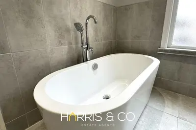 a white bath tub in a bathroom with a window at Admirals Rest in Fleetwood