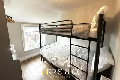 a bedroom with two bunk beds in a room at Admirals Rest in Fleetwood