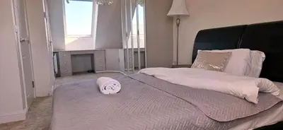 a bedroom with a large bed with a towel on it at House - Sleeps 11 - Parking - Station Close in Preston