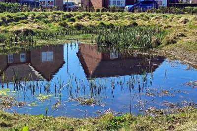 a reflection of a building in a pond at House - Sleeps 11 - Parking - Station Close in Preston