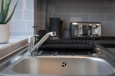 a kitchen sink with a strainer on top of it at Stylish 3-Bed Home-Liverpool in Liverpool