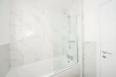 a white bathroom with a shower and a tub at Stylish 3-Bed Home-Liverpool in Liverpool