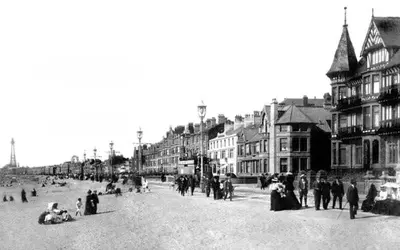 a black and white photo of a city street with people at The Sands Hotel in Blackpool