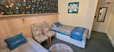 a hospital room with two beds and a chair at The Sands Hotel in Blackpool