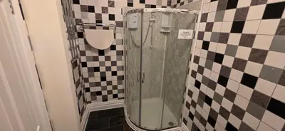 a shower with a glass door in a bathroom at The Sands Hotel in Blackpool