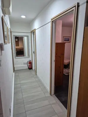 a hallway with a door and a mirror at Ulverston Town Centre Ground Floor Apartment in Ulverston