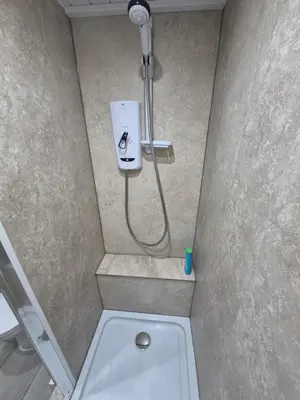 a bathroom with a shower with a toilet in it at Ulverston Town Centre Ground Floor Apartment in Ulverston