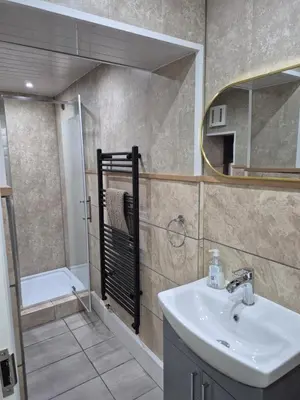 a bathroom with a sink and a mirror at Ulverston Town Centre Ground Floor Apartment in Ulverston