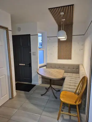 a living room with a table and a couch at Ulverston Town Centre Ground Floor Apartment in Ulverston