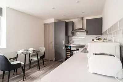 a kitchen with a table and a dining room at Convenient 1 Bedroom Apartment in Preston Centre in Preston