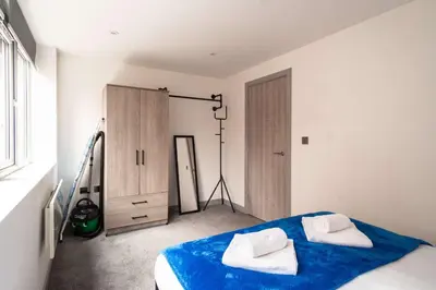 a bedroom with a bed with two towels on it at Convenient 1 Bedroom Apartment in Preston Centre in Preston