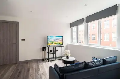 a living room with a couch and a flat screen tv at Convenient 1 Bedroom Apartment in Preston Centre in Preston