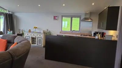 a kitchen with a couch and a counter top at Haven Lodge Kirkby In Furness, with views to the estuary and hot tub, ideal romantic break in Soutergate