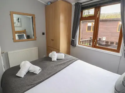 a bedroom with a bed with towels on it at Lakeside 18 in Carnforth