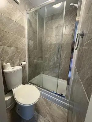 a bathroom with a toilet and a shower at The Harbour Inn in Barrow in Furness
