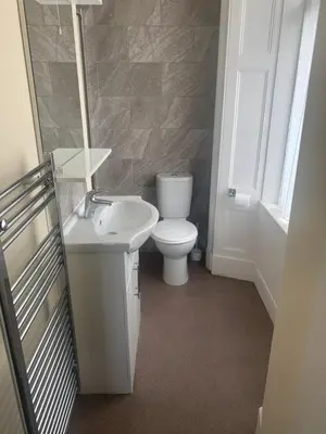 a bathroom with a white toilet and a sink at The Harbour Inn in Barrow in Furness