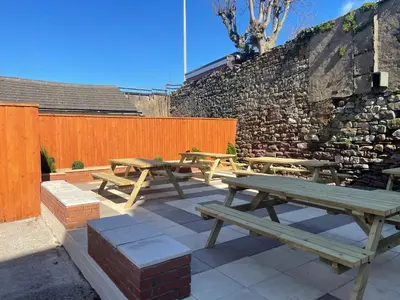 a group of picnic tables sitting on a patio at The Harbour Inn in Barrow in Furness