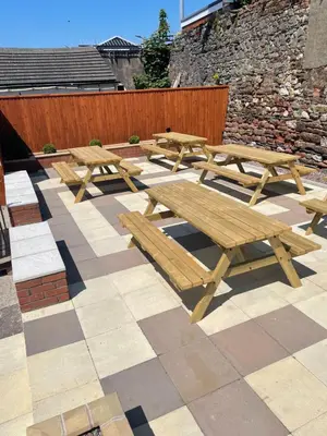 a group of picnic tables on a patio at The Harbour Inn in Barrow in Furness