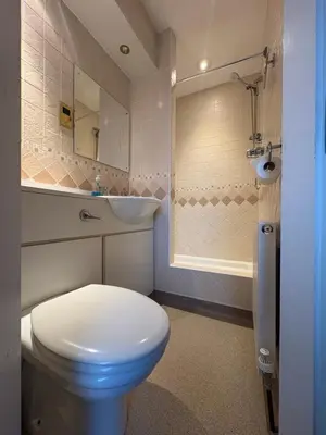 a bathroom with a white toilet and a sink at The Harbour Inn in Barrow in Furness