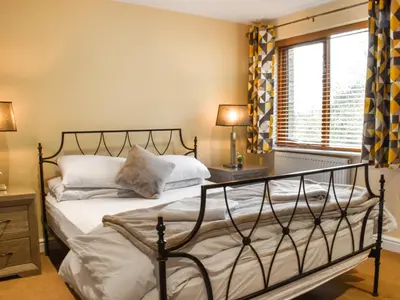 a bedroom with a bed and a window at Marina Haven in Carnforth