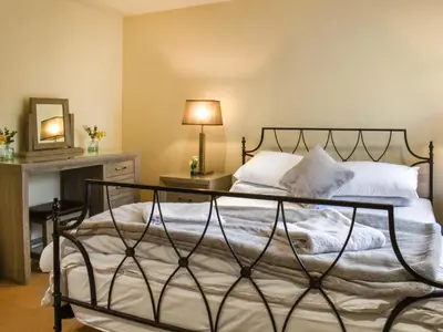 a bedroom with a bed and a table with a lamp at Marina Haven in Carnforth