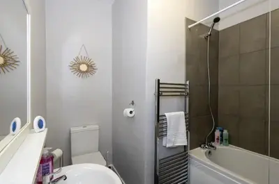 a bathroom with a toilet and a sink and a tub at Cosy 2 Bed House for Contractors in Accrington