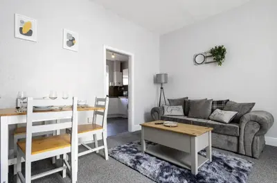 a living room with a couch and a table at Cosy 2 Bed House for Contractors in Accrington