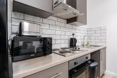 a kitchen with a microwave oven and a sink at Roof Terrace WM Smart TV Free Parking in Liverpool