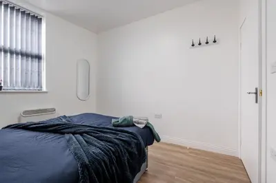 a bedroom with a bed and a window at Near LFC & City Budget LongTerm Free Parking in Liverpool