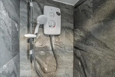 a shower in a bathroom with a blow dryer at Near LFC & City Budget LongTerm Free Parking in Liverpool