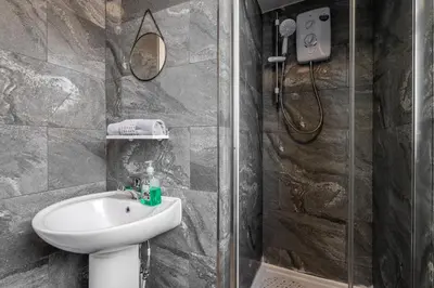 a bathroom with a sink and a shower at Near LFC & City Budget LongTerm Free Parking in Liverpool
