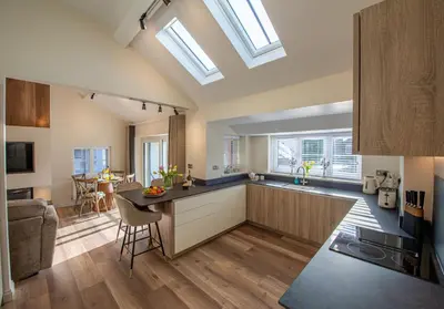 a kitchen with skylights and a kitchen island with a counter at Olive Lodge Lytham in Lytham St Annes
