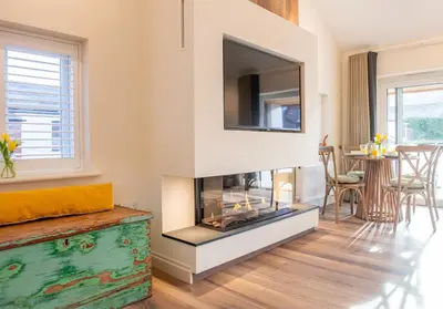 a living room with a fireplace and a tv at Olive Lodge Lytham in Lytham St Annes