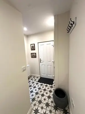 a hallway with a black and white tile floor at Scallop Lodge Lytham in Lytham St Annes