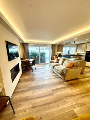a living room with a couch and a table at Scallop Lodge Lytham in Lytham St Annes