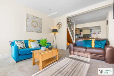 a living room with two couches and a table at Miriam's House in Saint Helens