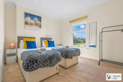 a bedroom with two beds and a window at Miriam's House in Saint Helens