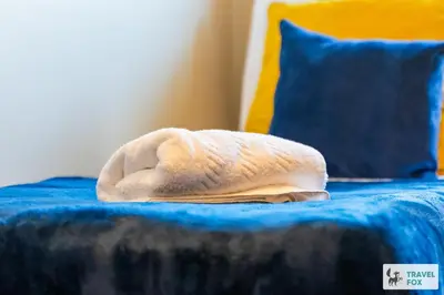 a white towel sitting on top of a bed at Miriam's House in Saint Helens