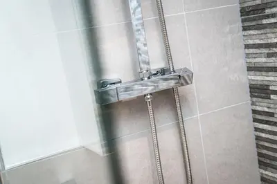 a shower with a metal sink in a bathroom at Chavasse Cove Sleeping 6 Guests With Parking in Liverpool