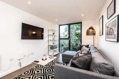 a living room with a couch and a table at Chavasse Cove Sleeping 6 Guests With Parking in Liverpool
