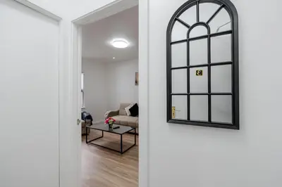 a door leading into a living room with a mirror at Ideal Work Trips Washer SofaBed Free Parking in Liverpool