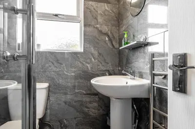 a bathroom with a sink and a toilet at Ideal Work Trips Washer SofaBed Free Parking in Liverpool