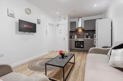 a living room with a couch and a table at TopFloor Apt LikeHome Long-Term Free Parking in Liverpool