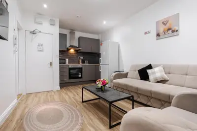 a living room with a couch and a table at TopFloor Apt LikeHome Long-Term Free Parking in Liverpool