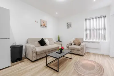 a living room with a couch and a table at TopFloor Apt LikeHome Long-Term Free Parking in Liverpool