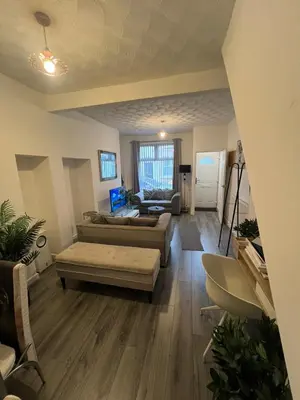 a living room with a couch and a table at Anfield cosy stay in Liverpool