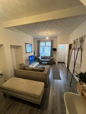 a living room with a couch and a table at Anfield cosy stay in Liverpool