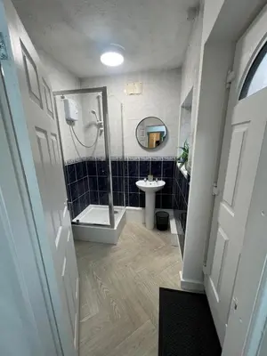 a bathroom with a shower and a sink at Anfield cosy stay in Liverpool