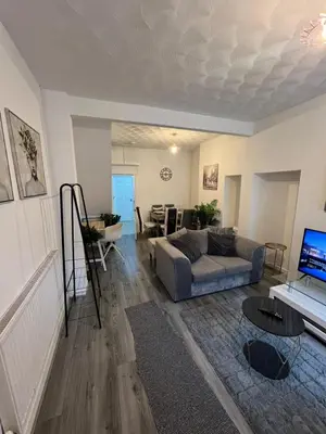 a living room with a couch and a table at Anfield cosy stay in Liverpool
